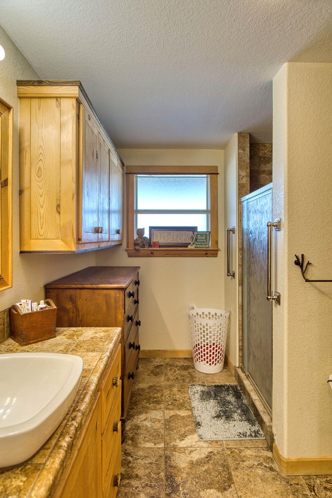 6446 Blackjack Road Fredonia, TX 76842 - Photo 45 of 52 a bathroom with a sink and a mirror