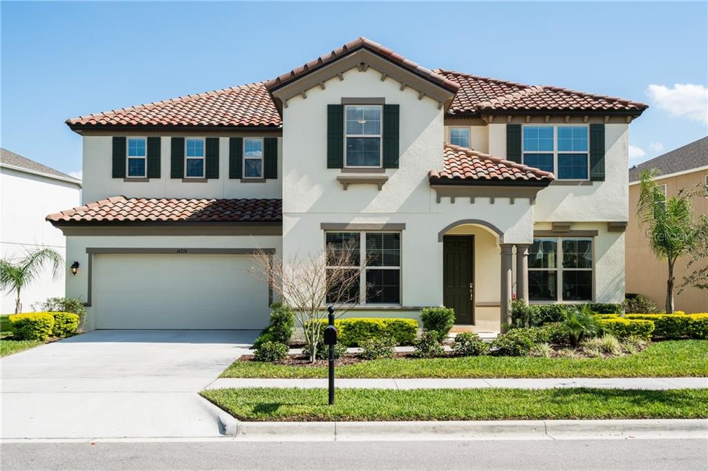 14334 Magnolia Ridge Loop Winter Garden, FL 34787 - Photo 1 of 1 a front view of a house with a yard and garage