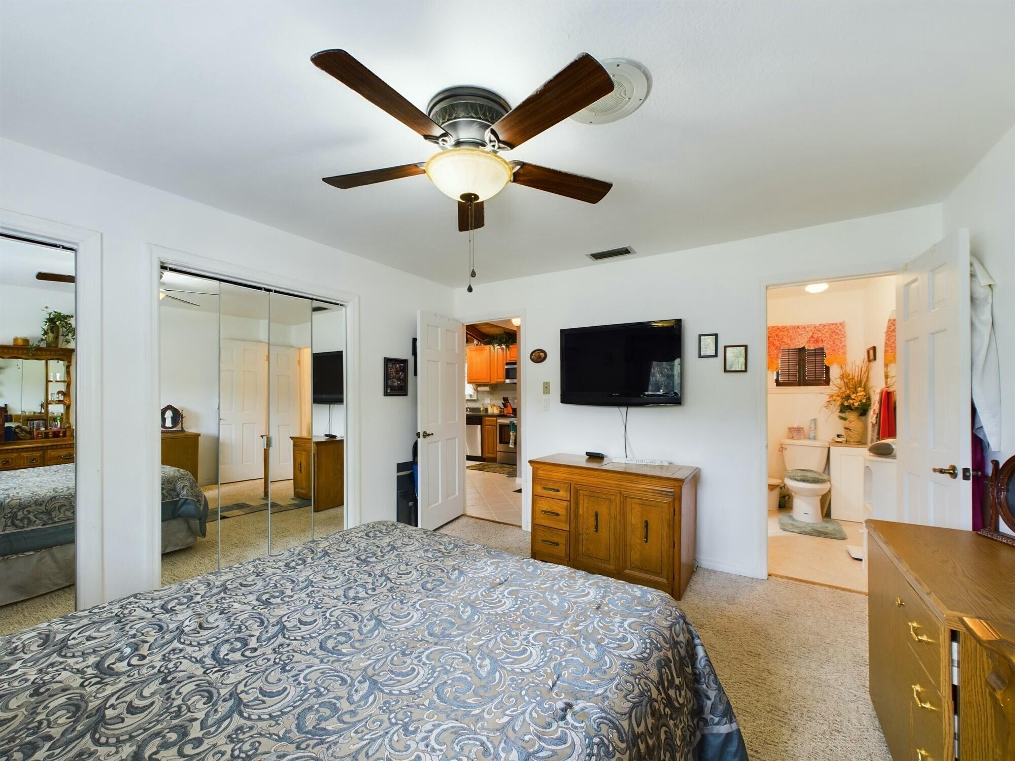 1517 Southwest 7th Avenue Okeechobee, FL 34974 - Photo 25 of 51 a bedroom with furniture and a flat screen tv