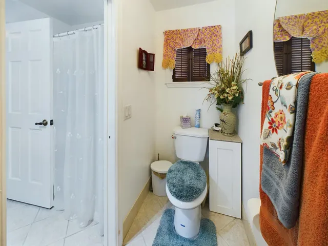 a en suite bathroom with a granite countertop sink and a mirror