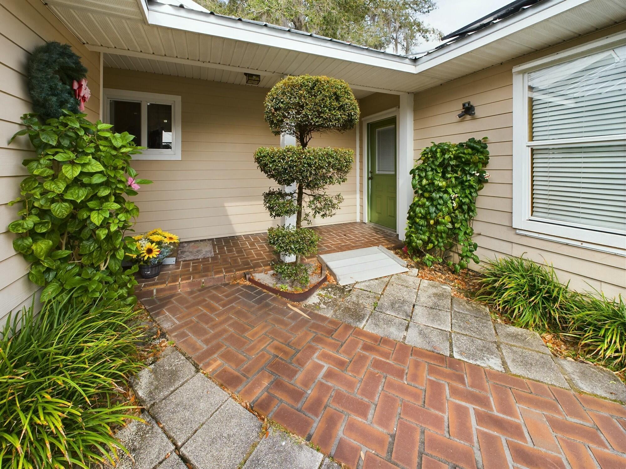 1517 Southwest 7th Avenue Okeechobee, FL 34974 - Photo 28 of 51 a view of a porch with chairs and potted plants