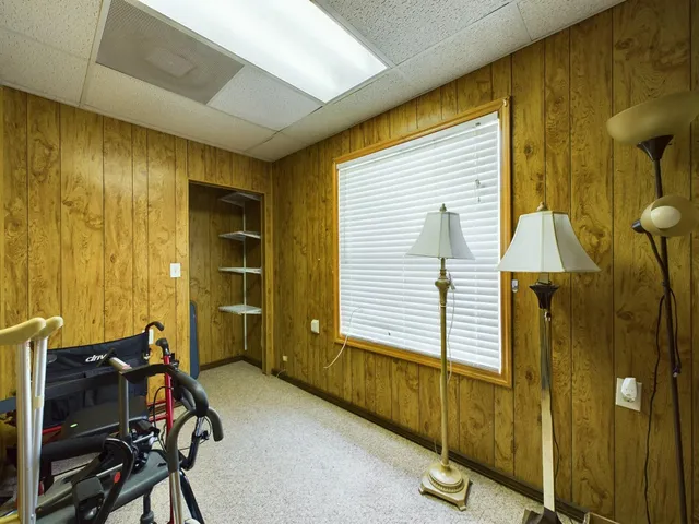 a living room with furniture flowerpot and a flat screen tv