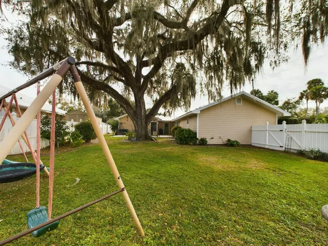 a view of yard with grass and trees