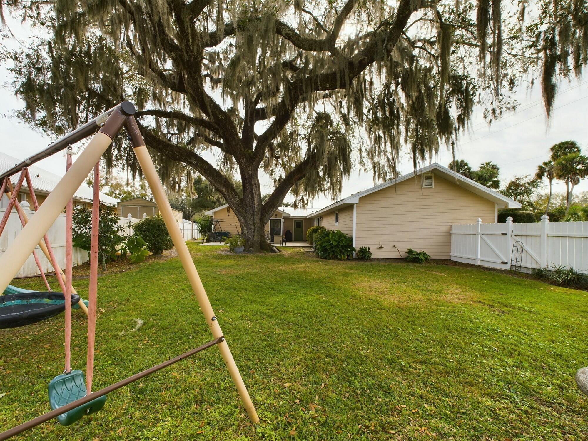 1517 Southwest 7th Avenue Okeechobee, FL 34974 - Photo 42 of 51 a backyard of a house with table and chairs