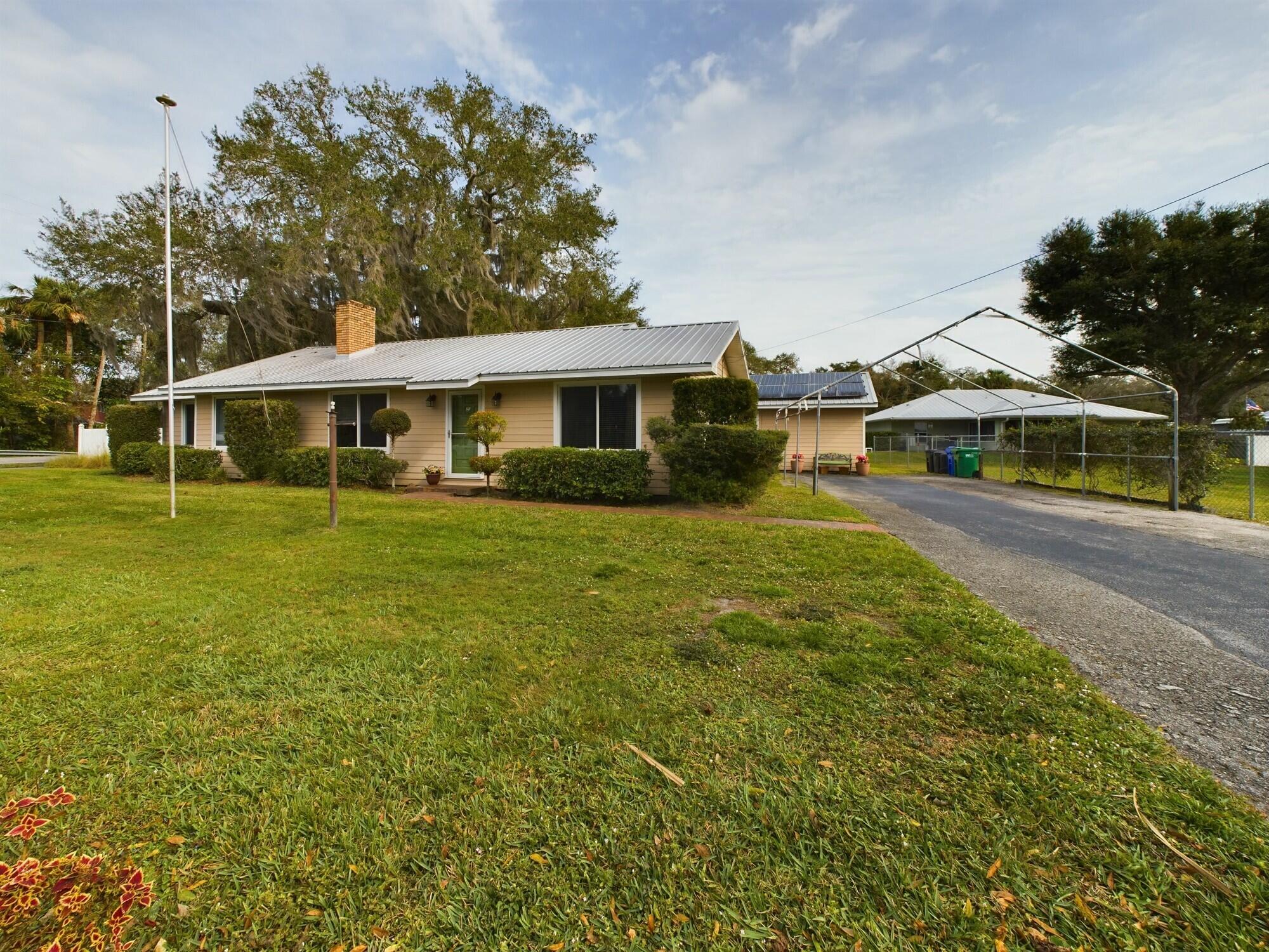 1517 Southwest 7th Avenue Okeechobee, FL 34974 - Photo 50 of 51 a front view of a house with a garden