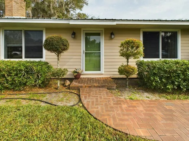 a view of a house with potted plants