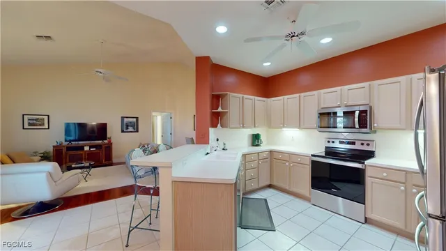 a kitchen with stainless steel appliances kitchen island granite countertop a sink counter space cabinets and stainless steel appliances