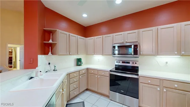 a kitchen with stainless steel appliances a sink stove and cabinets