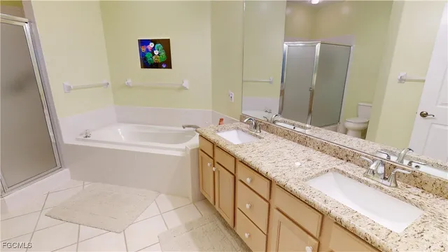 a bathroom with a granite countertop sink and a bathtub