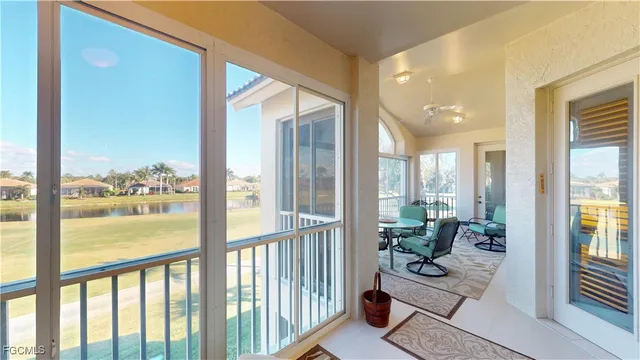 a view of living room filled with furniture and floor to ceiling window