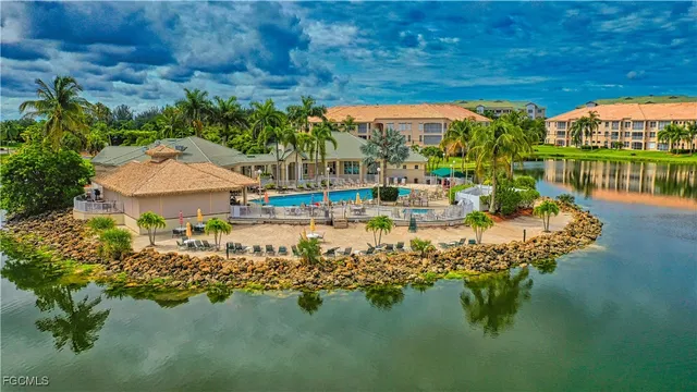 a view of a swimming pool with a yard and plants