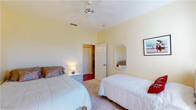 a bedroom with a bed and a painting on the wall