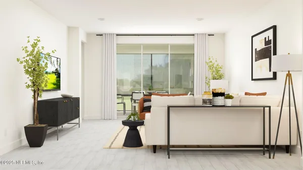 a living room with furniture and a potted plant