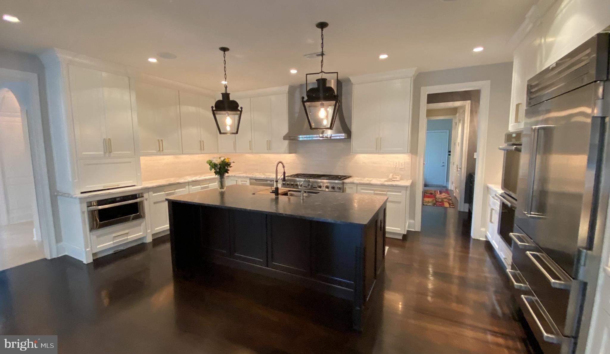 206 Valley Ridge Road Haverford, PA 19041 - Photo 13 of 48 a kitchen with kitchen island granite countertop a sink appliances and cabinets