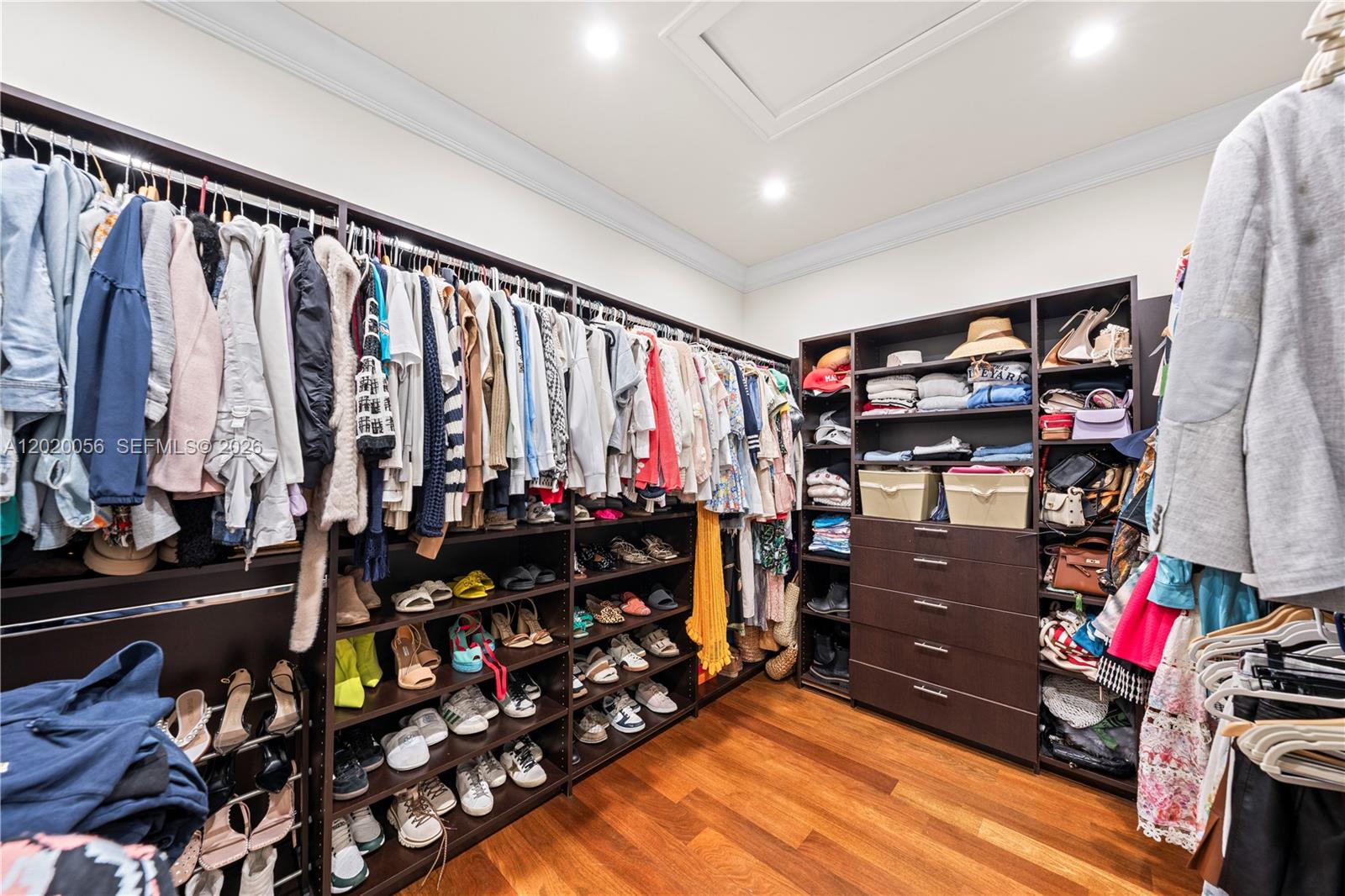 4196 Douglas Road Miami, FL 33133 - Photo 57 of 96 a view of walk in closet with clothes and shoes