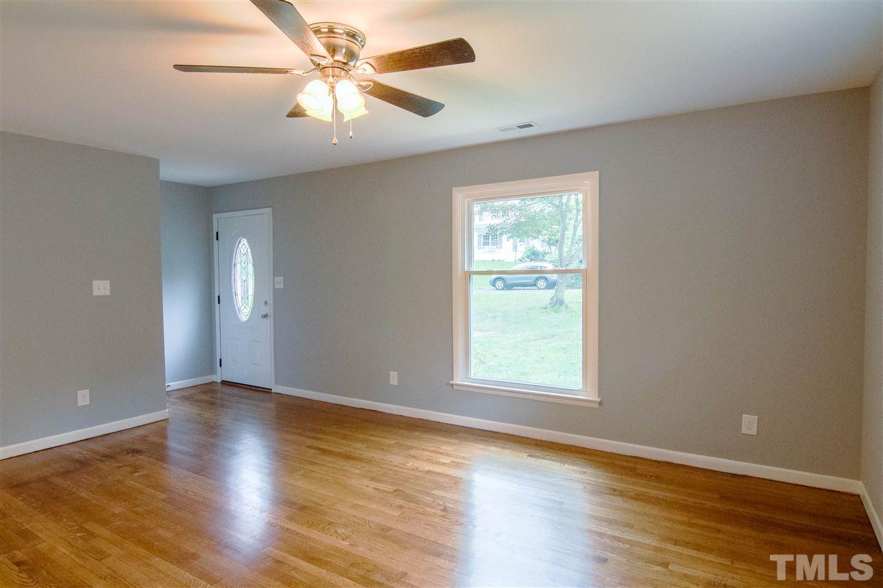 4608 Huntington Court Raleigh, NC 27609 - Photo 3 of 10 an empty room with wooden floor and windows