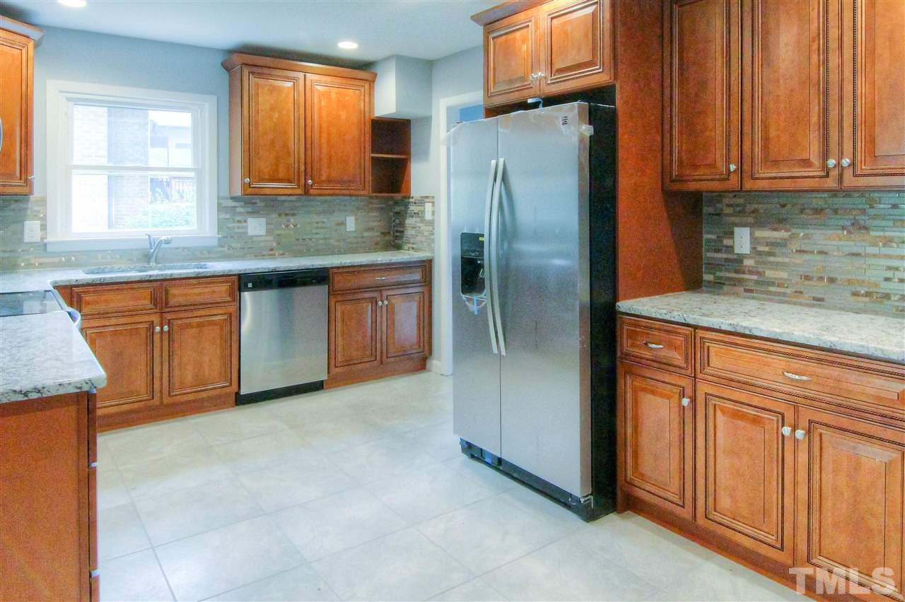 4608 Huntington Court Raleigh, NC 27609 - Photo 5 of 10 a kitchen with stainless steel appliances granite countertop a refrigerator a sink and dishwasher