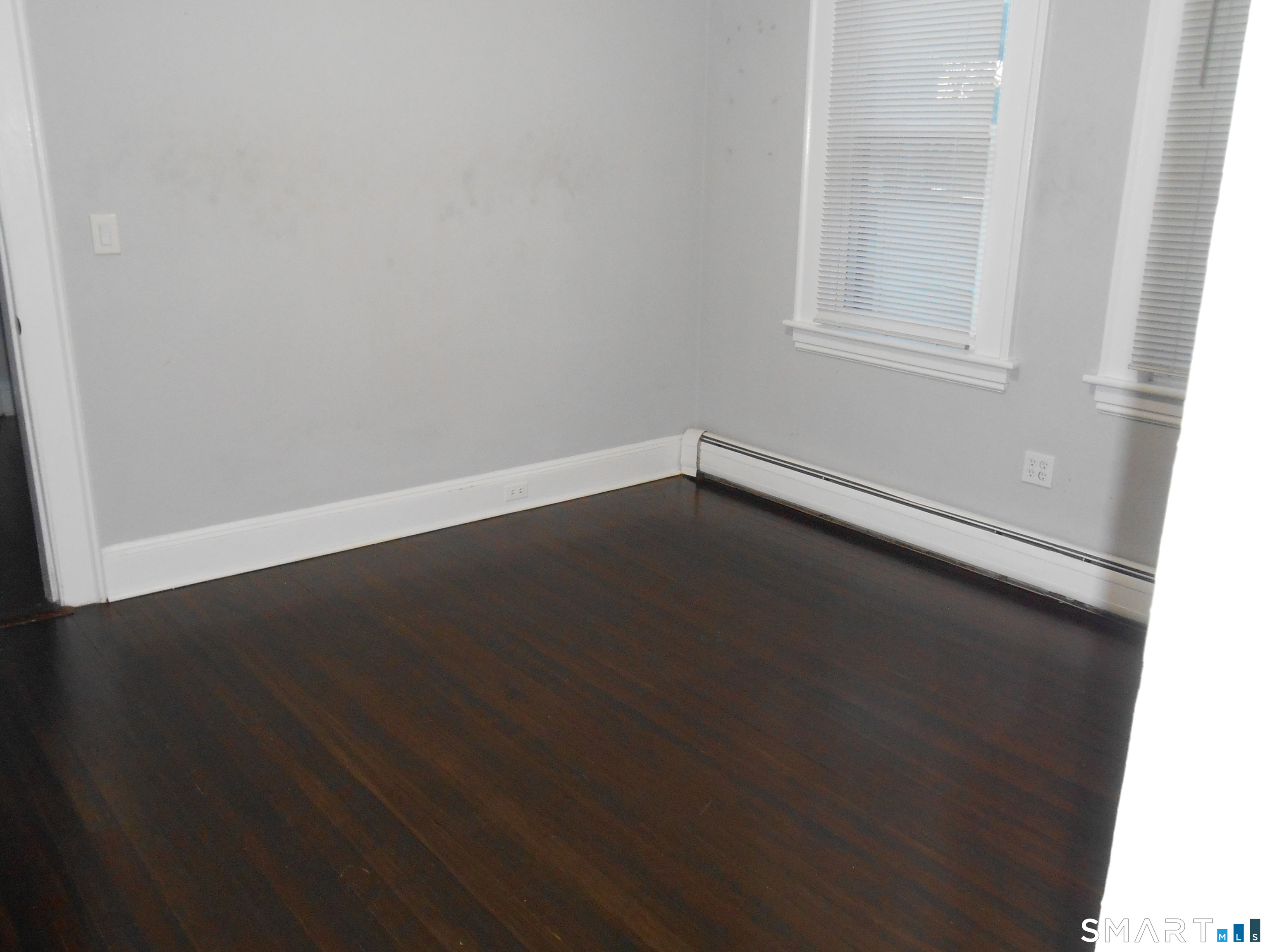 254 Wayne Street Bridgeport, CT 06606 - Photo 13 of 25 an empty room with wooden floor and windows