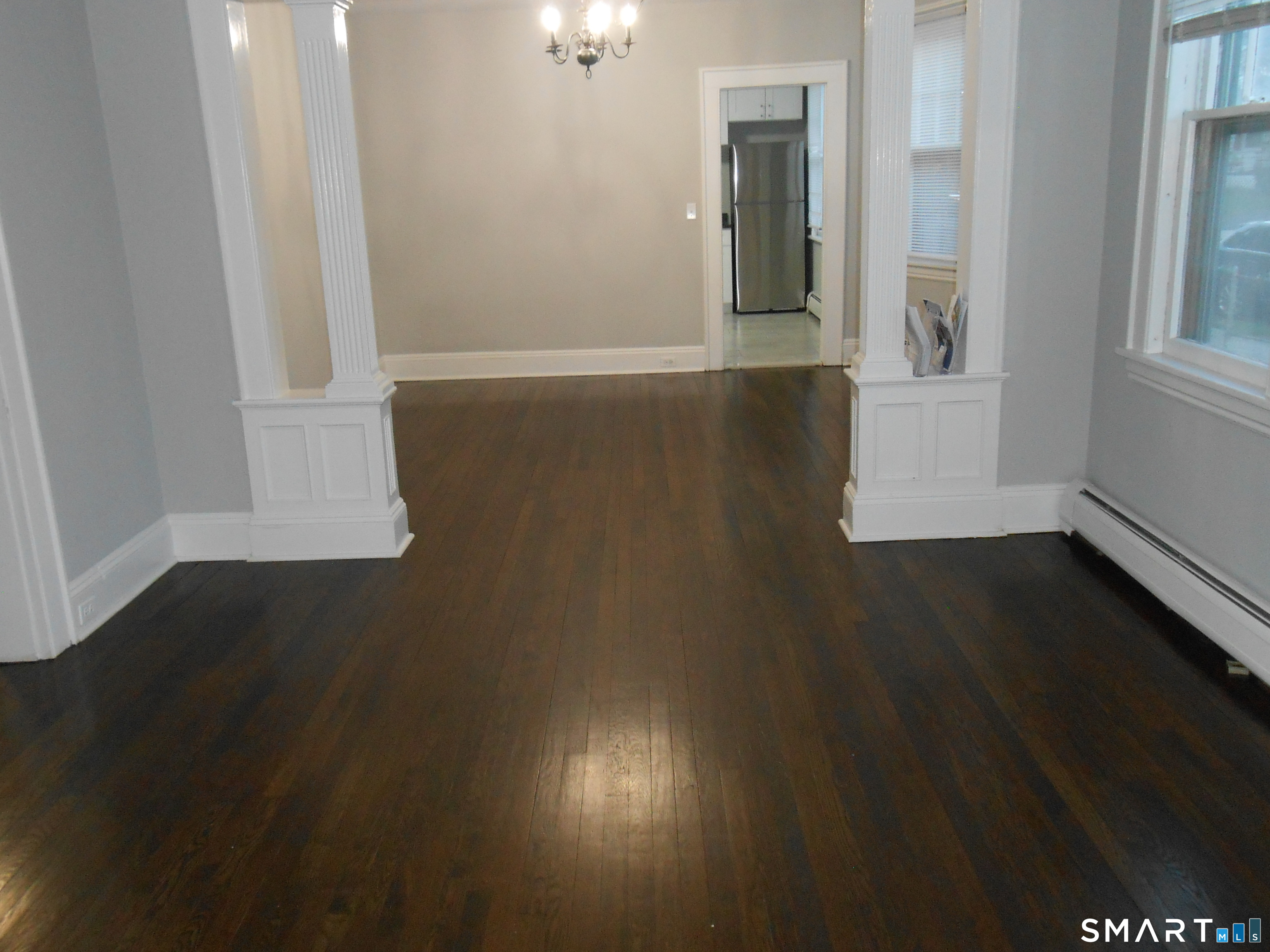 254 Wayne Street Bridgeport, CT 06606 - Photo 14 of 25 an empty room with wooden floor and windows