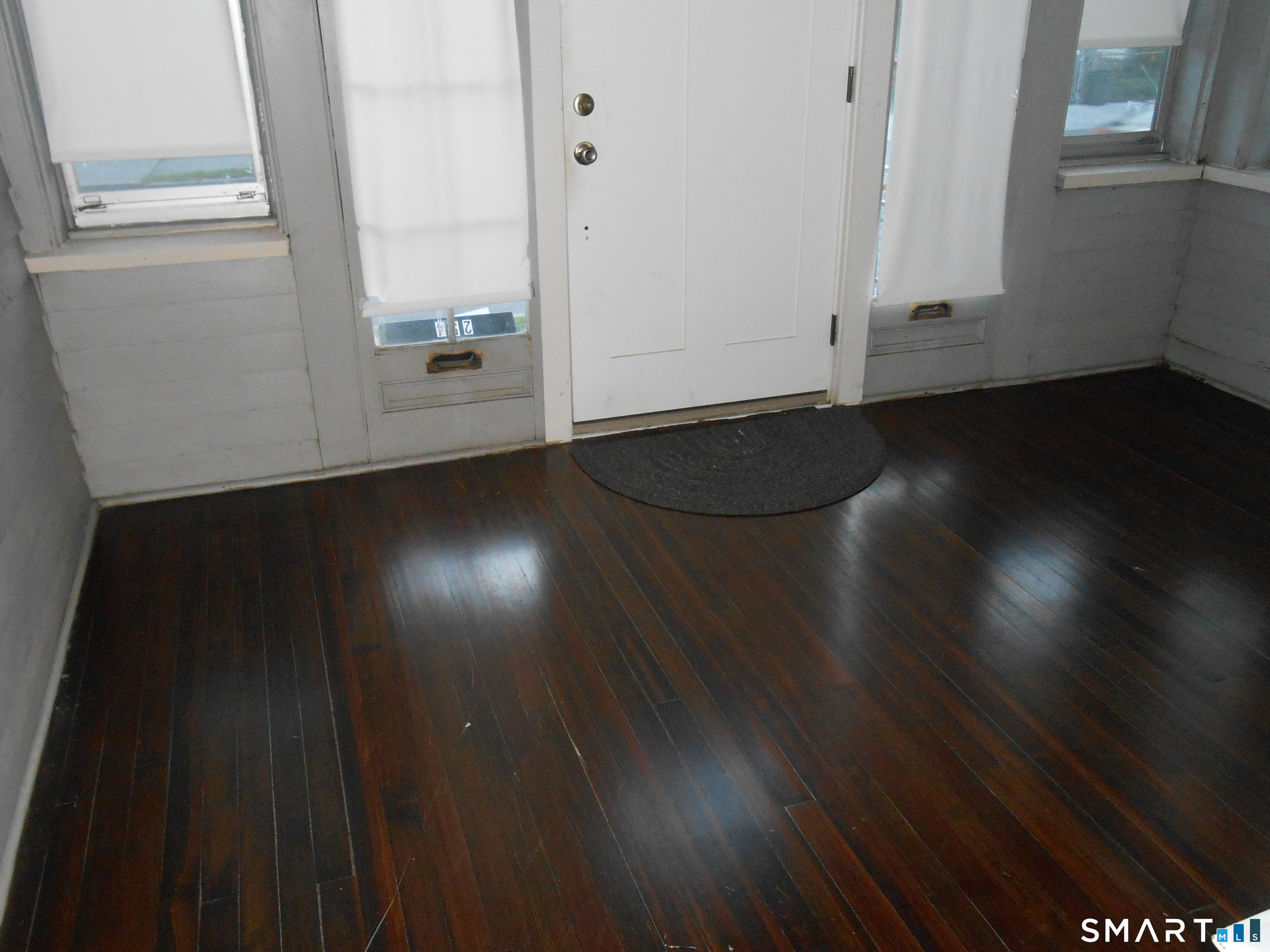 254 Wayne Street Bridgeport, CT 06606 - Photo 18 of 25 an empty room with wooden floor and windows