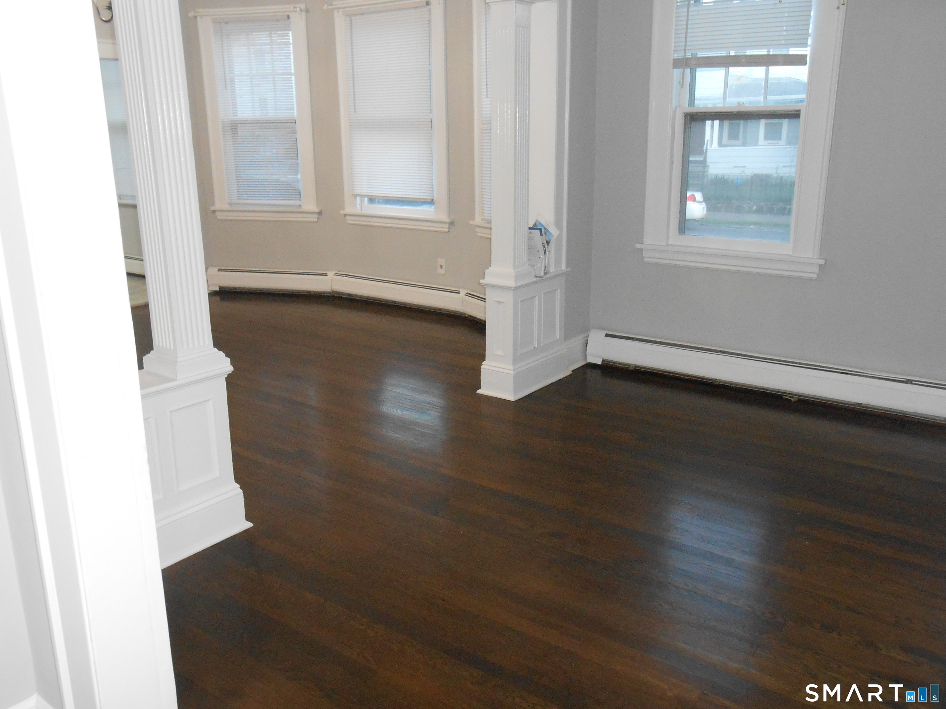254 Wayne Street Bridgeport, CT 06606 - Photo 19 of 25 an empty room with wooden floor and windows
