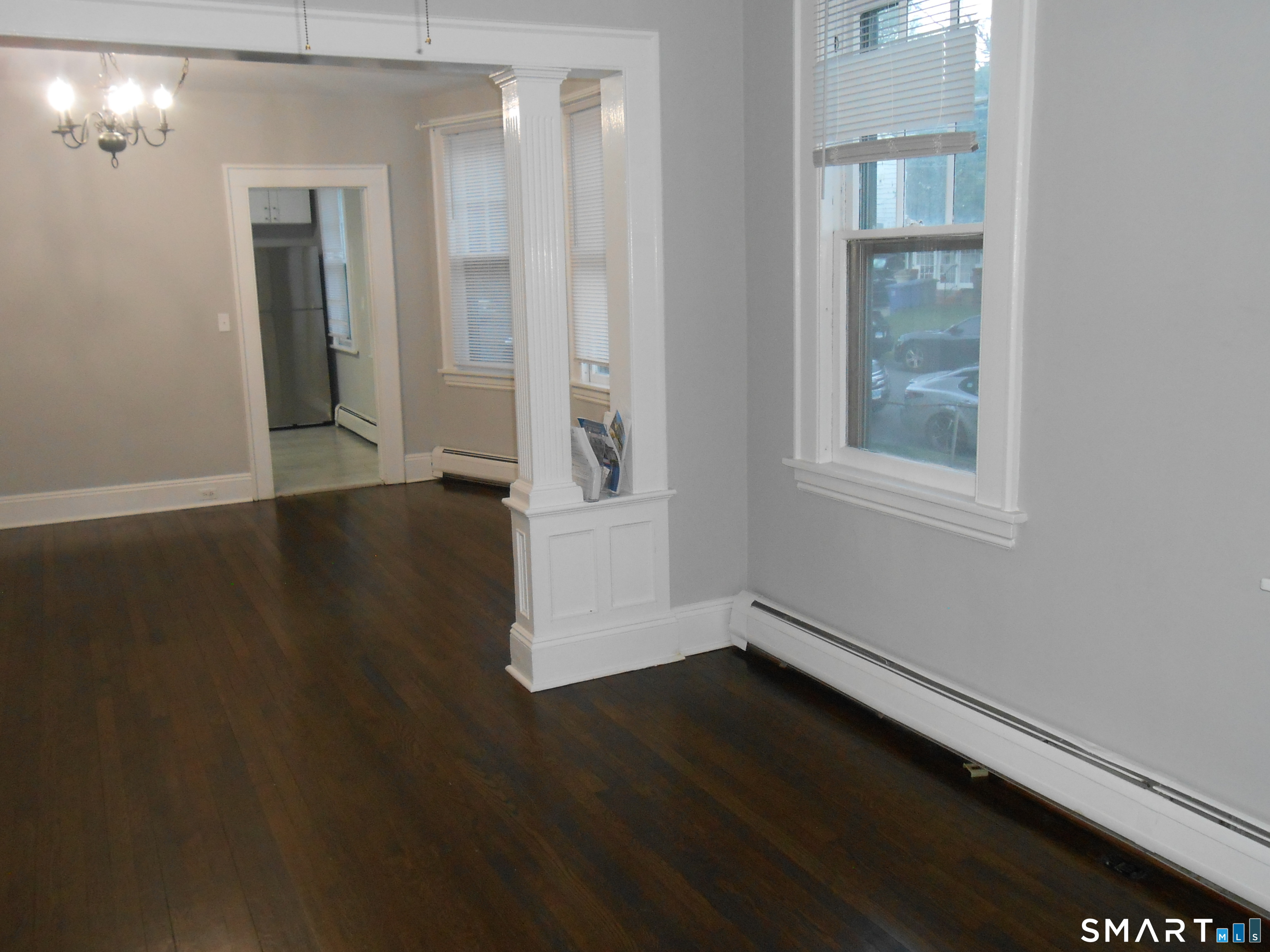 254 Wayne Street Bridgeport, CT 06606 - Photo 20 of 25 an empty room with wooden floor and windows