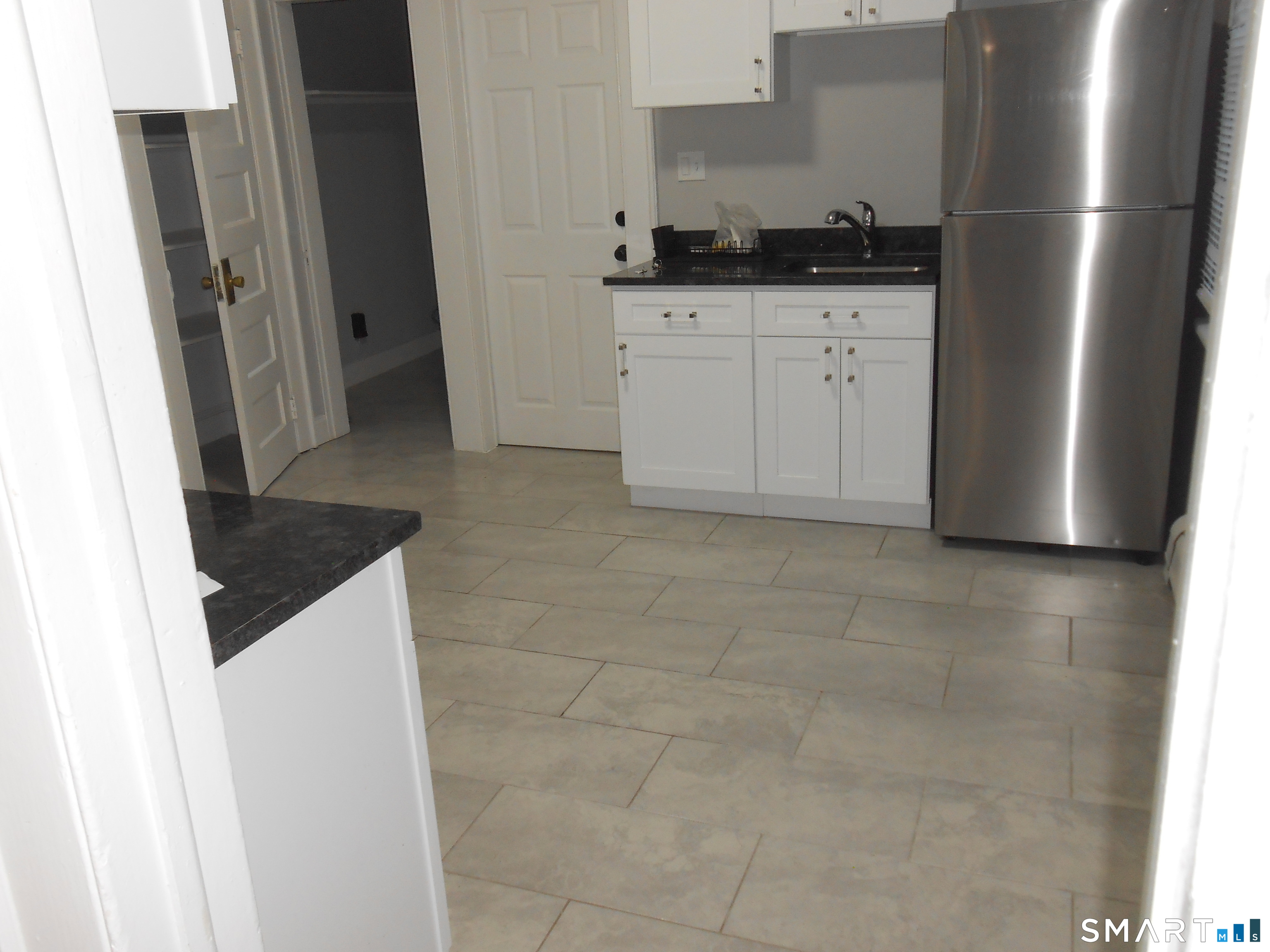 254 Wayne Street Bridgeport, CT 06606 - Photo 21 of 25 a kitchen with a sink and a refrigerator