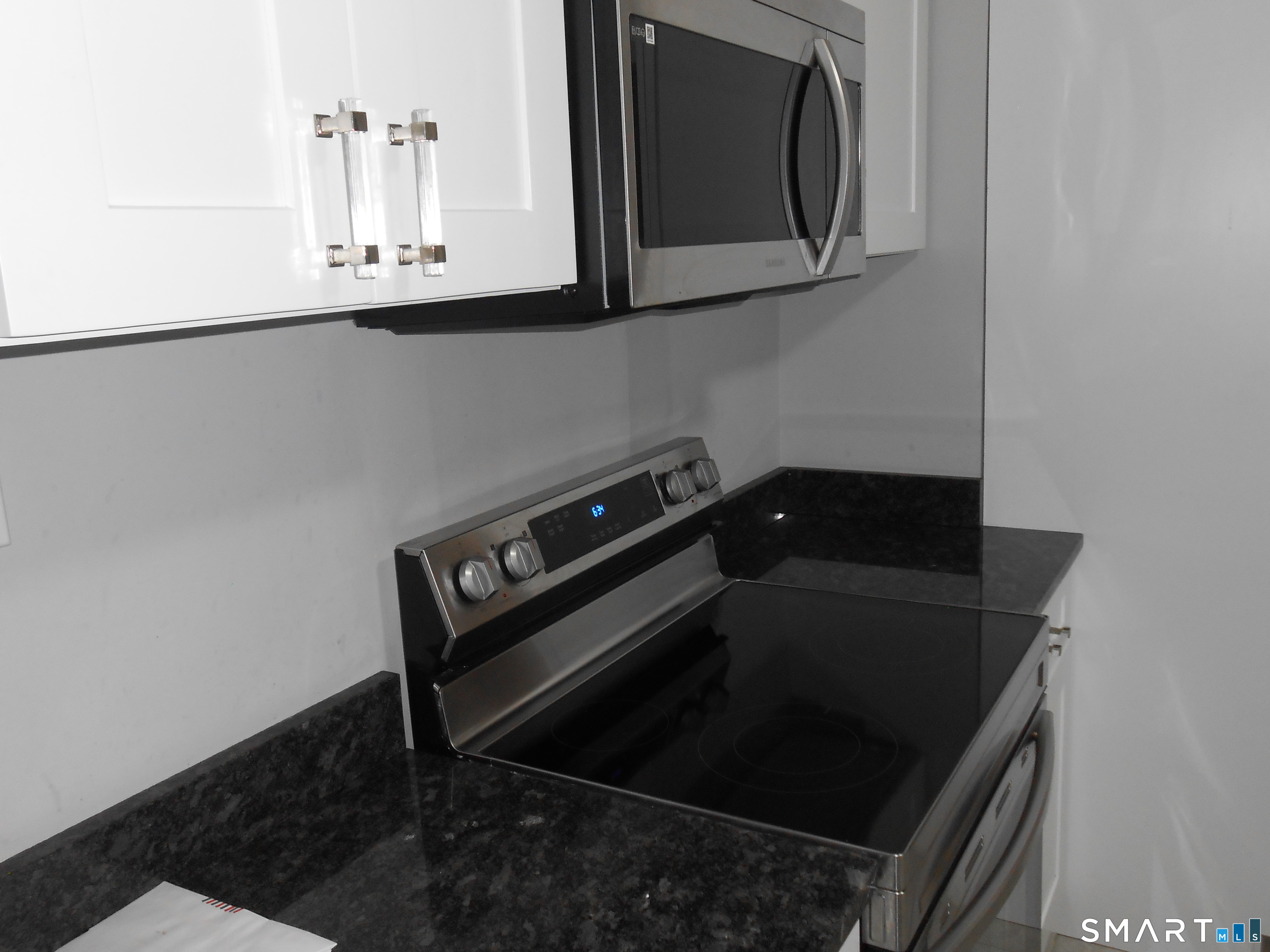 254 Wayne Street Bridgeport, CT 06606 - Photo 23 of 25 a close view of a stove a microwave and cabinets