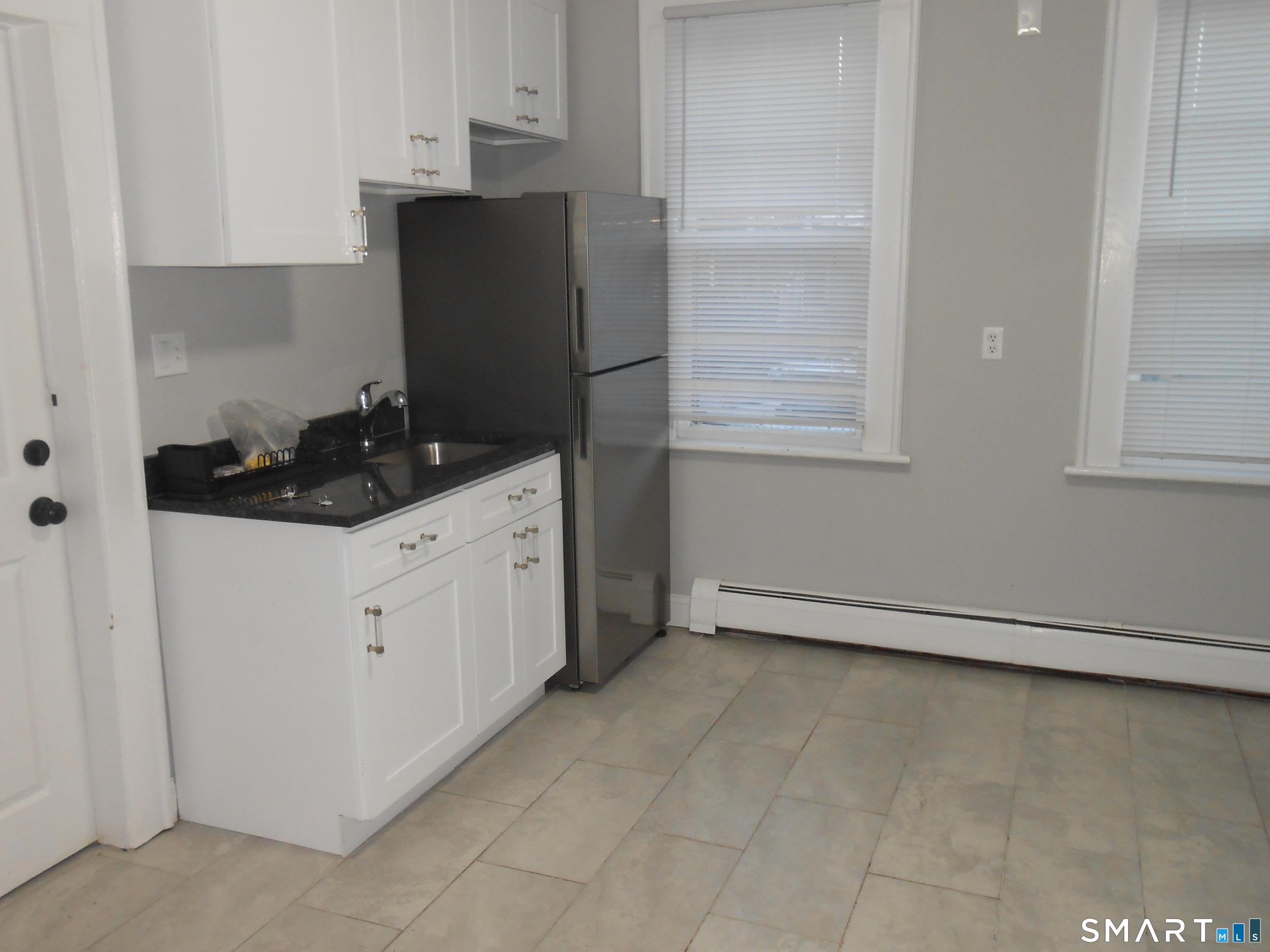 254 Wayne Street Bridgeport, CT 06606 - Photo 7 of 25 a kitchen with a sink and cabinets