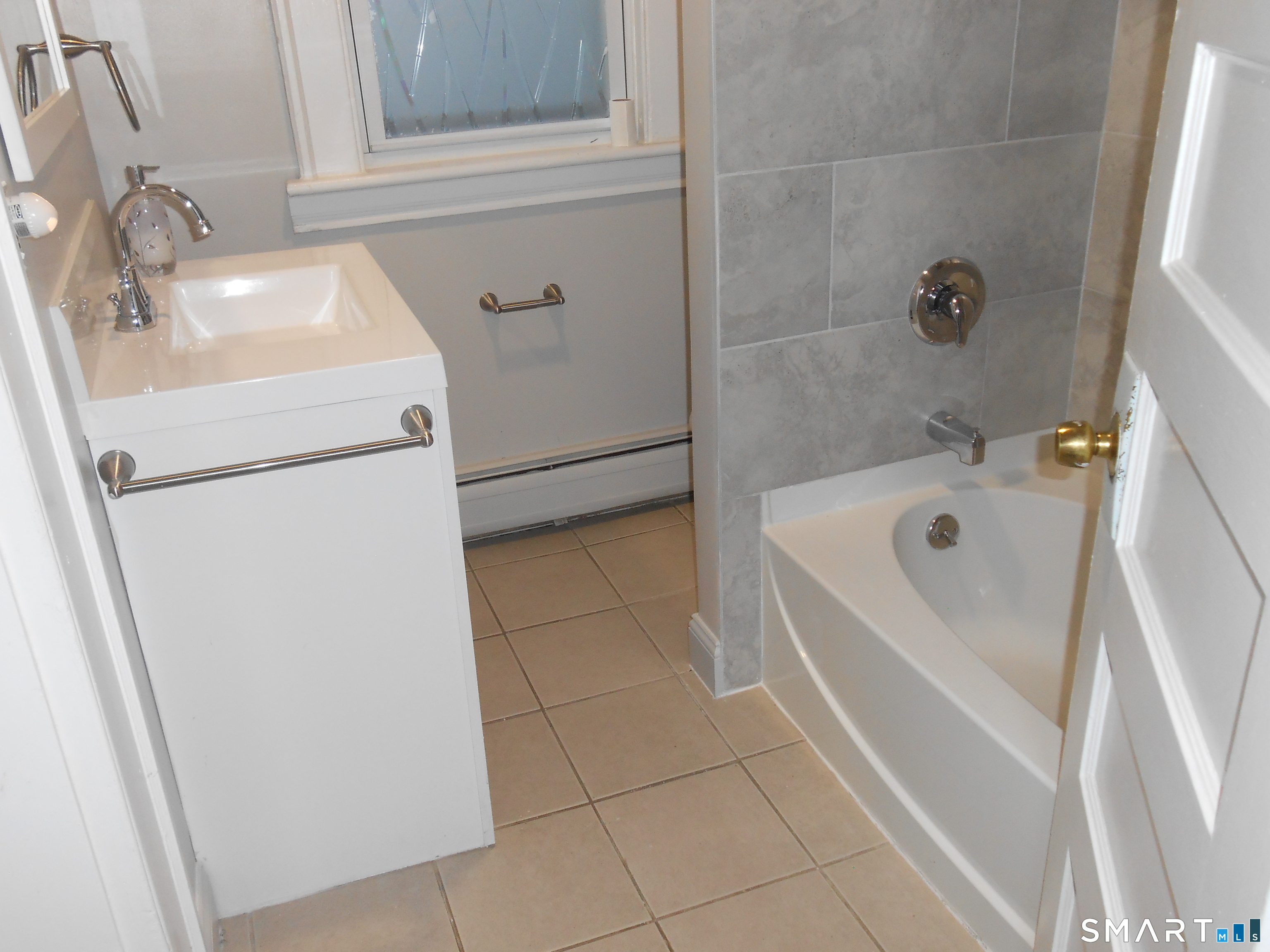 254 Wayne Street Bridgeport, CT 06606 - Photo 9 of 25 a bathroom with a sink and a bathtub