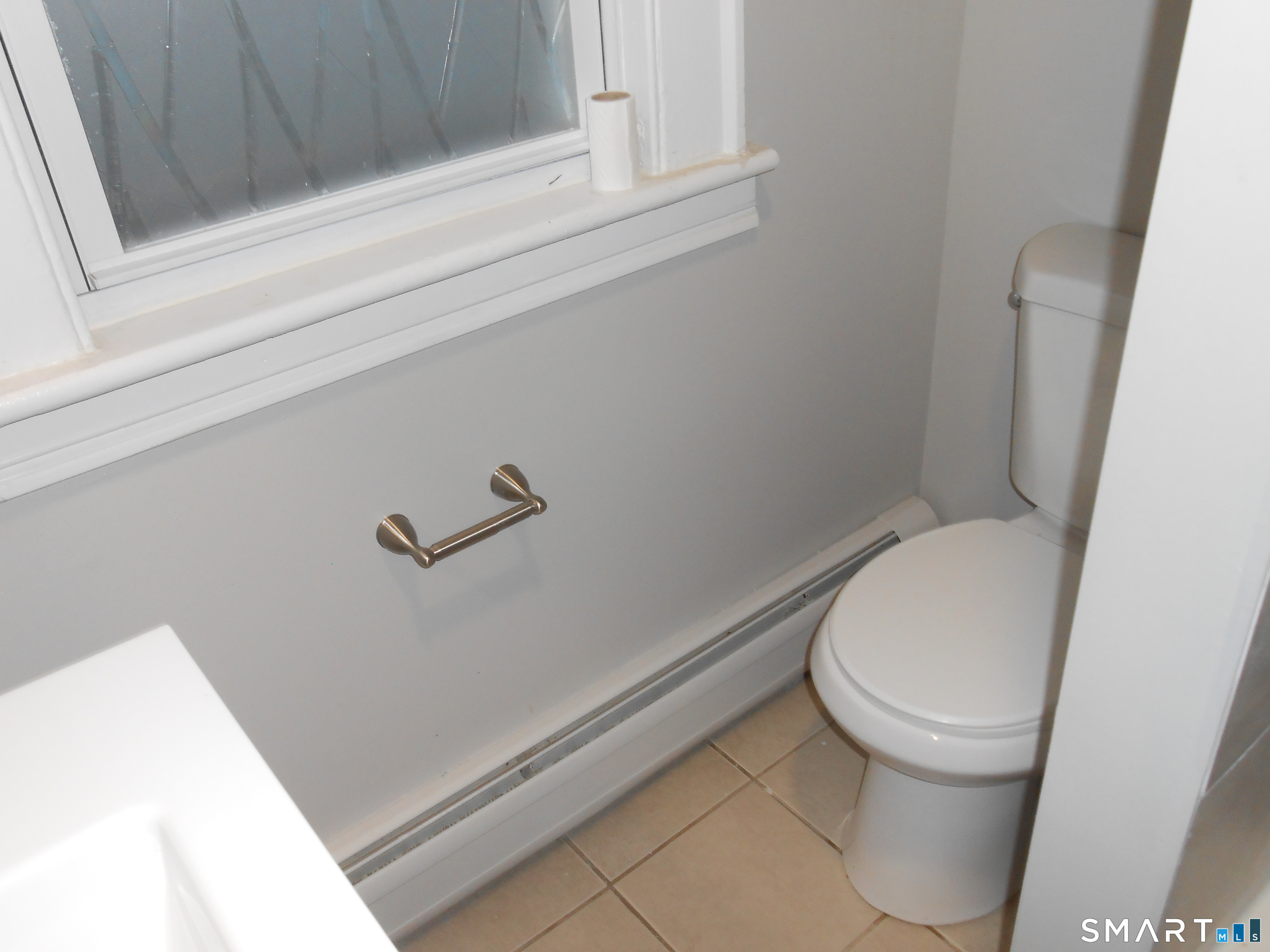 254 Wayne Street Bridgeport, CT 06606 - Photo 10 of 25 a white toilet sitting next to a sink