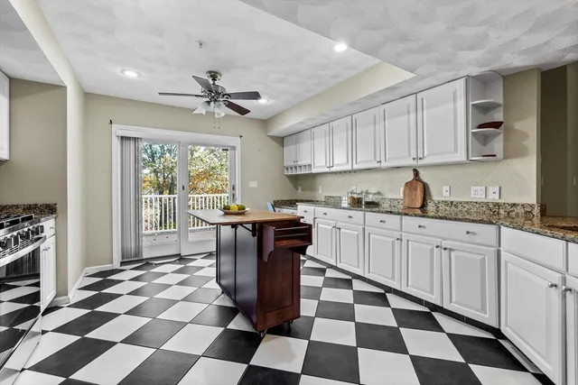 a kitchen with a checkered floor and white cabinets