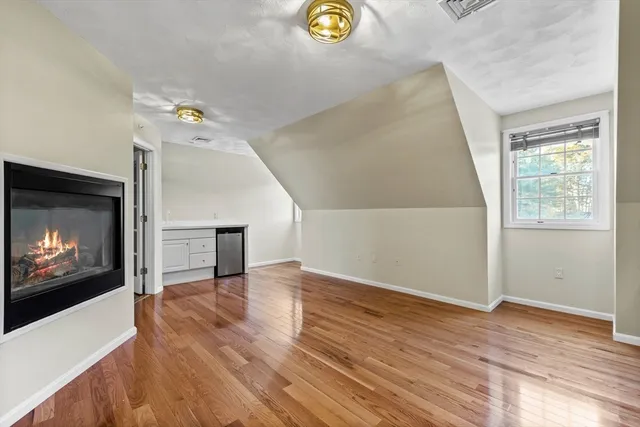 a view of an empty room and wooden floor