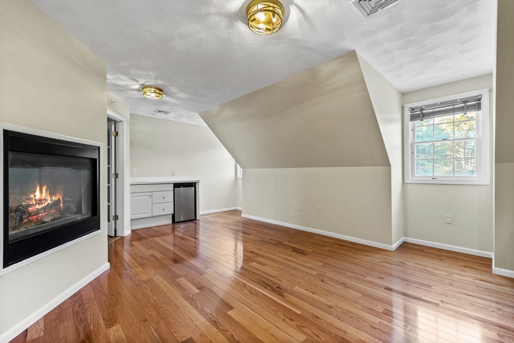 30 Maytum Way, Unit 30 Middleton, MA 01949 - Photo 19 of 42 a view of an empty room and wooden floor