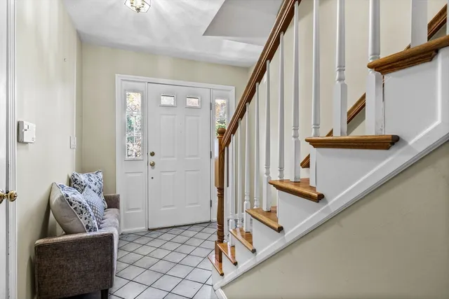 a living room with furniture and stairs