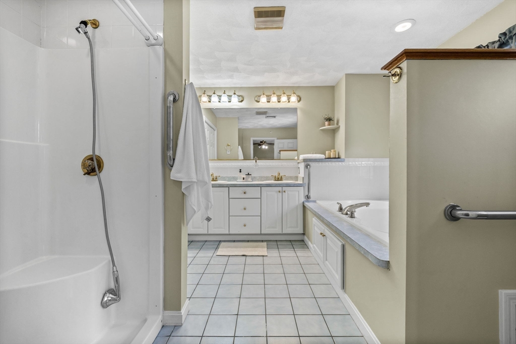 30 Maytum Way, Unit 30 Middleton, MA 01949 - Photo 28 of 42 a bathroom with a granite countertop sink a toilet and shower