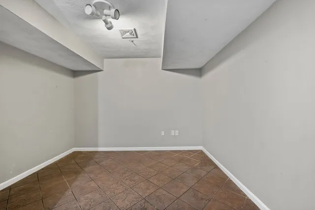 a view of a hallway with a chandelier fan