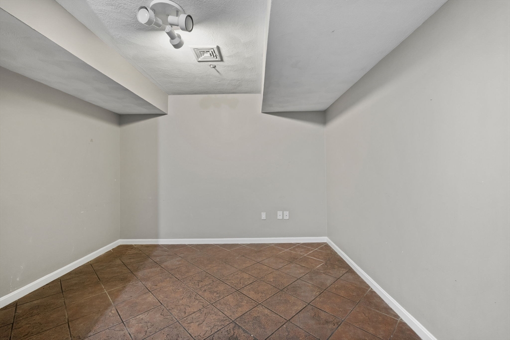 30 Maytum Way, Unit 30 Middleton, MA 01949 - Photo 30 of 42 a view of a hallway with a chandelier fan