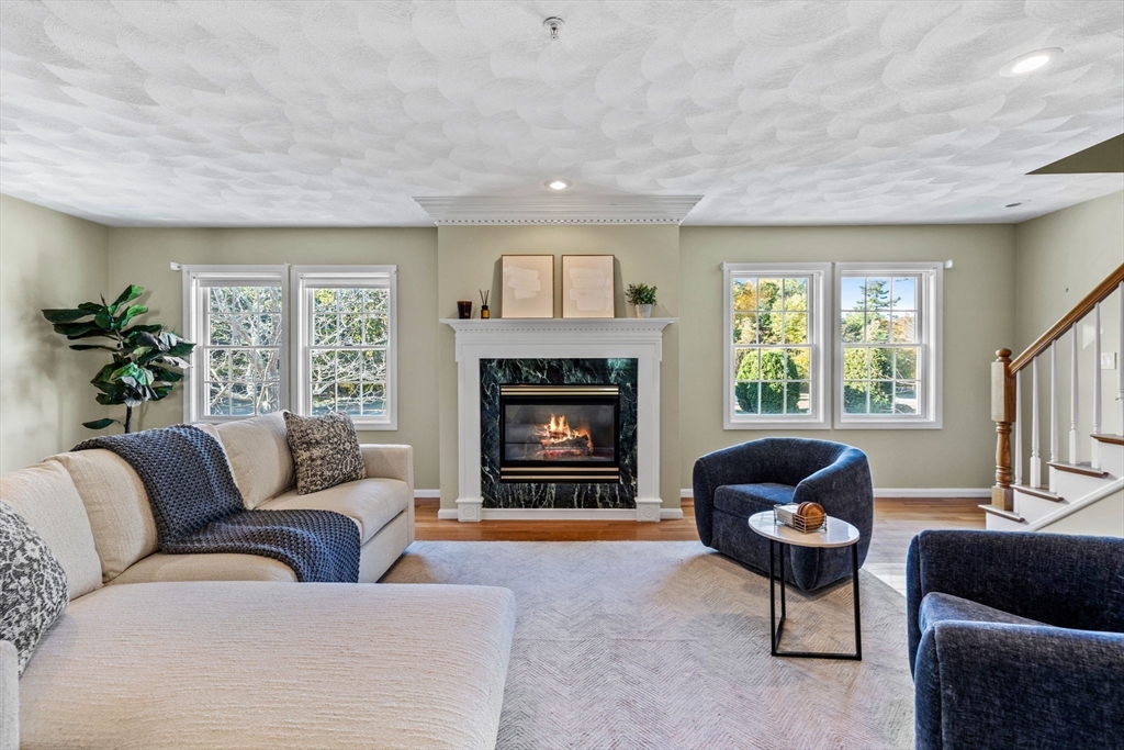30 Maytum Way, Unit 30 Middleton, MA 01949 - Photo 3 of 42 a living room with furniture and a fireplace