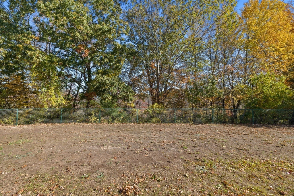 30 Maytum Way, Unit 30 Middleton, MA 01949 - Photo 36 of 42 a view of a field with trees in the background