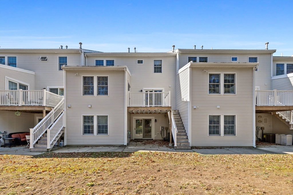 30 Maytum Way, Unit 30 Middleton, MA 01949 - Photo 37 of 42 a front view of a house with a yard