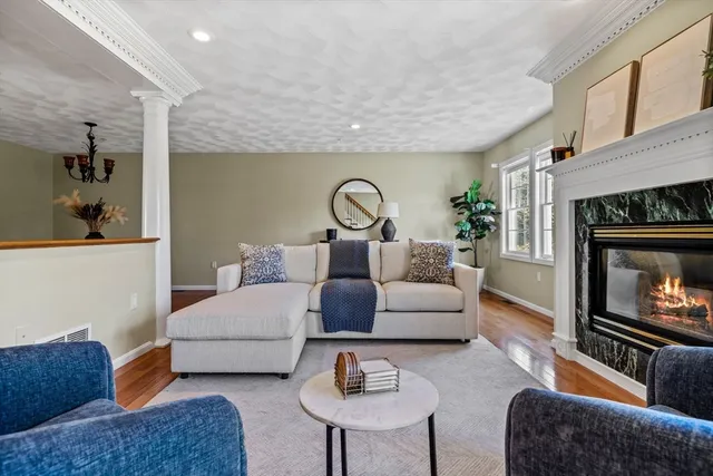 a living room with furniture white walls and a fireplace