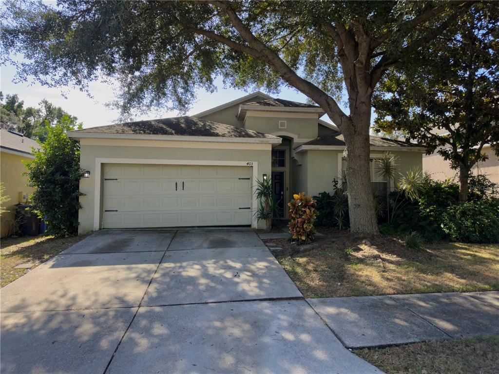 a view of a house with a yard and garage