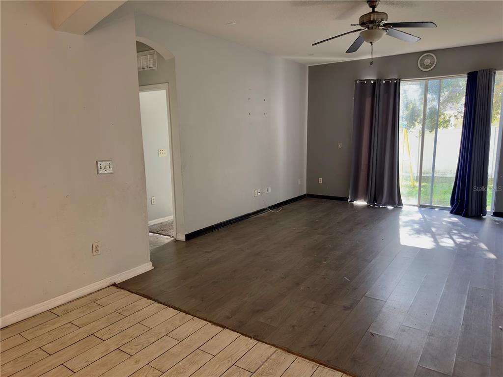 403 Thicket Crest Road Seffner, FL 33584 - Photo 11 of 28 an empty room with wooden floor and windows