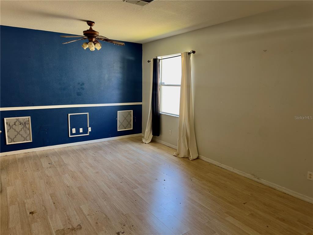 403 Thicket Crest Road Seffner, FL 33584 - Photo 7 of 28 a view of an empty room with wooden floor