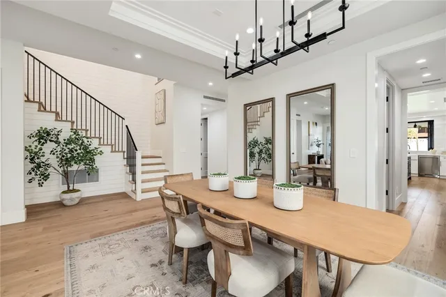 a kitchen with kitchen island stainless steel appliances a sink a stove and a refrigerator