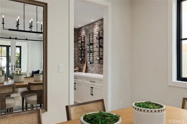 a large kitchen with kitchen island granite countertop lots of white cabinets a dining table and chairs