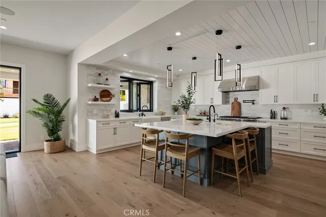 an empty room with a ceiling fan and windows