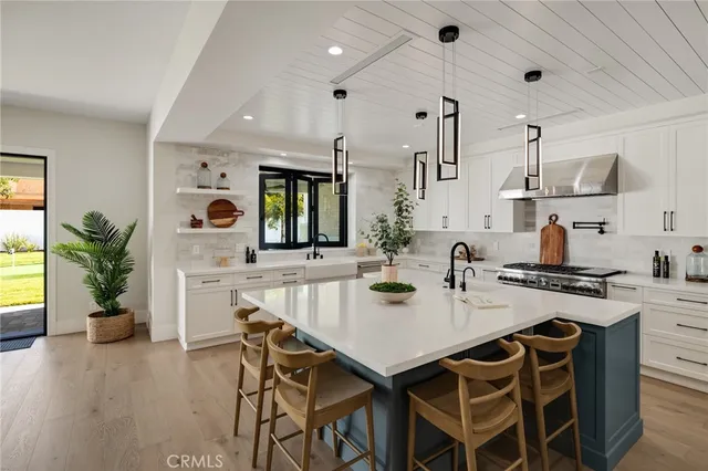 a living room with furniture large window and wooden floor