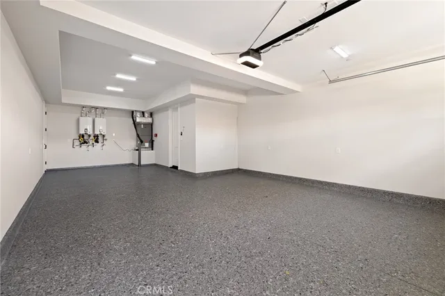 a bedroom with a bed a couch and potted plant